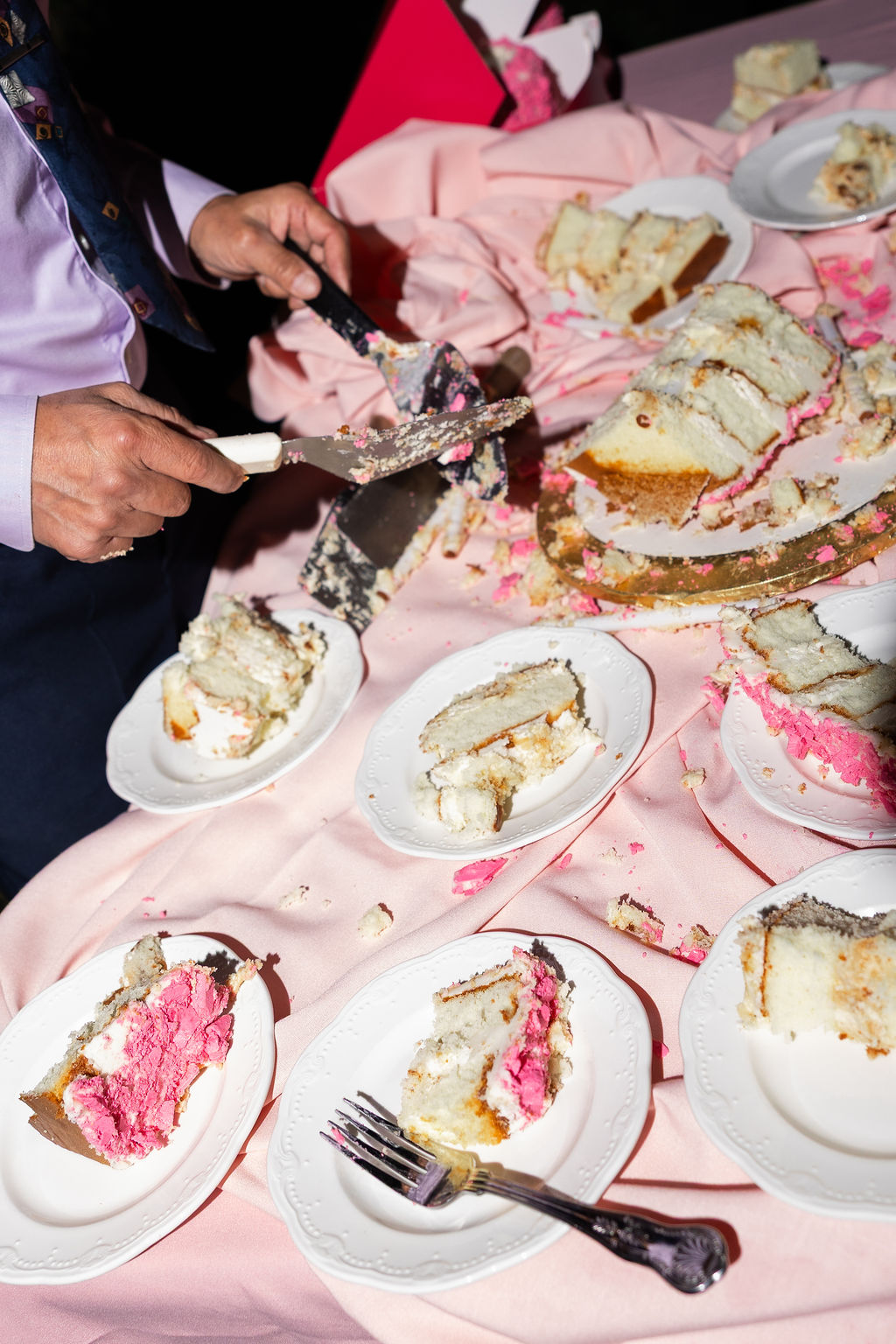 Details of cake slices across a pink table for a Madonna Inn wedding reception