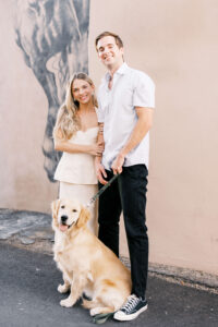 Couple poses with their golden retriever for the engagement photos