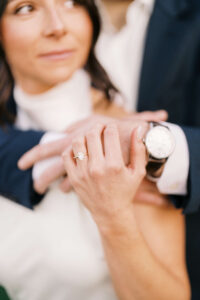 A closeup of an engagement ring and watch for engagement photo details 