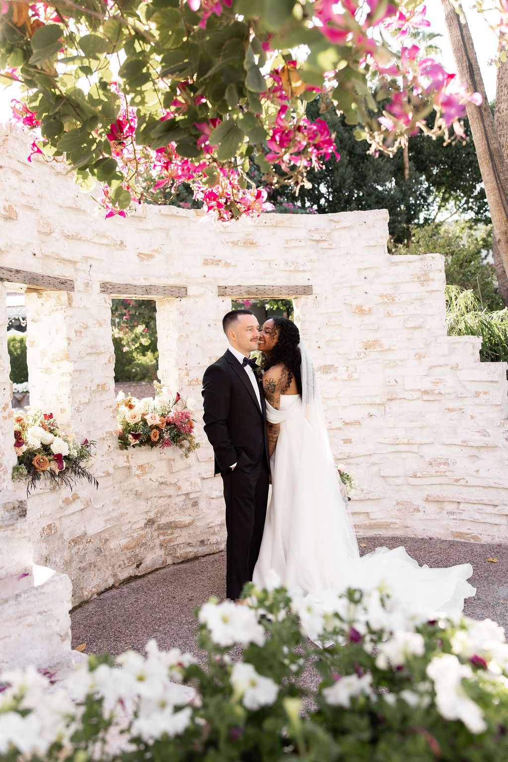 A bride and groom giggle while in a flower garden at the scott resort wedding venue