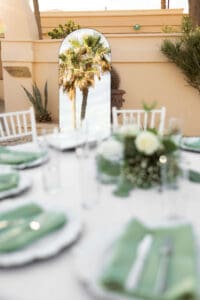 A well designed reception area in Cabo San Lucas showing green linens and palms
