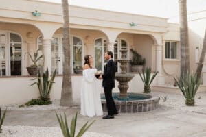 A couple exchanges vows in front of their villa in Cabo San Lucas